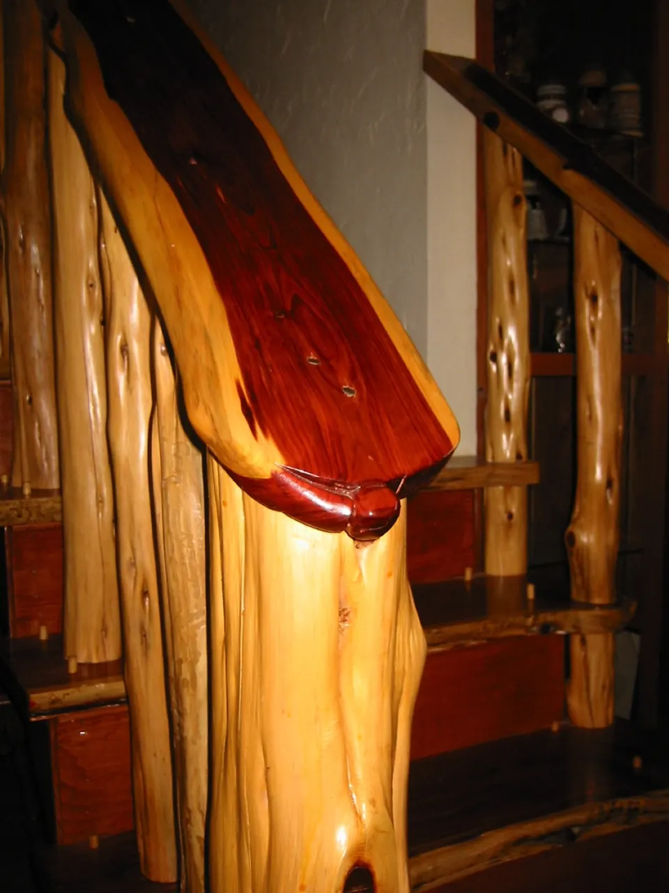 Staircase with a natural cedar handrail and balusters