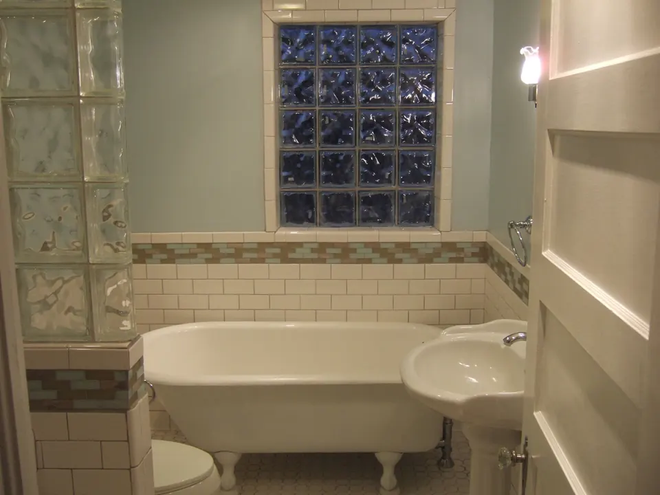 Bathroom with clawfoot tub, glass-block window and tile wainscot
