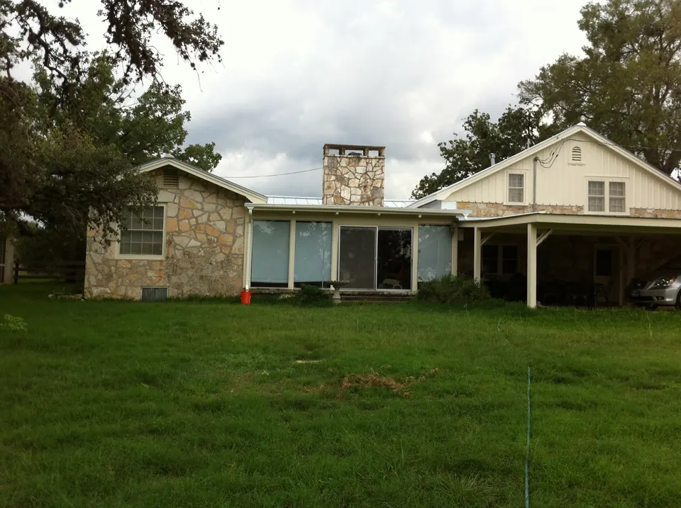 Stone ranch house with a white board-and-batten gable